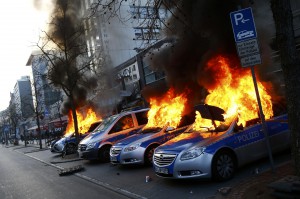 Four German police cars set on fire by anti-capitalist protesters burn near the new ECB headquarters in downtown Frankfurt